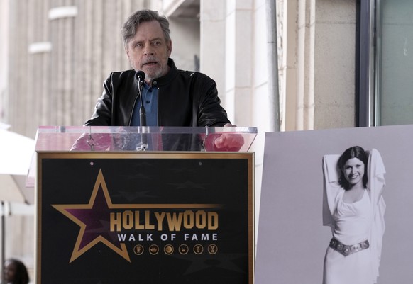 Mark Hamill speaks at a ceremony honoring the late actress Carrie Fisher, pictured at right, with a posthumous star on the Hollywood Walk of Fame in Los Angeles on Thursday, May 4, 2023, also known as ...
