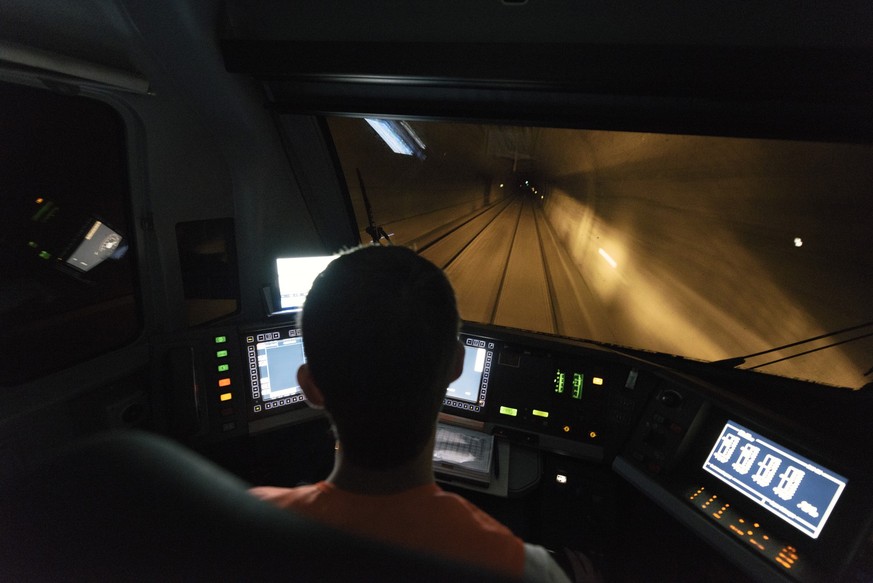 A train driver drives a BLS cargo train with an engine of the type Lok Re 465 014-9, pictured in the Loetschberg Base Tunnel on the journey from Brig, Canton of Valais, to Kandersteg, Canton of Berne, ...