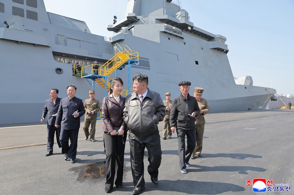 epa12063939 A photo released by the official North Korean Central News Agency (KCNA) shows North Korean Leader Kim Jong Un (centre-R) and daughter Kim Ju Ae (centre-L) attending the first test firing  ...