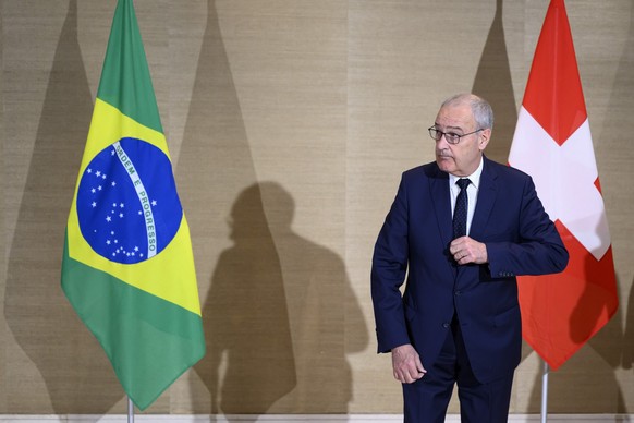 Swiss Federal President Guy Parmelin, right, prepares himself to welcome Brazil's President Luiz Inacio Lula da Silva, not pictured, prior to a bilateral meeting on the sideline of the the Evian ...
