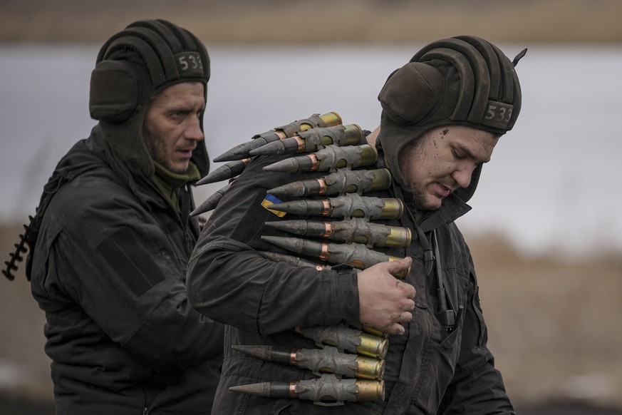 File - A Ukrainian serviceman carries large caliber ammunitions for armored fighting vehicles mounted weapons during an exercise in a Joint Forces Operation controlled area in the Donetsk region, east ...