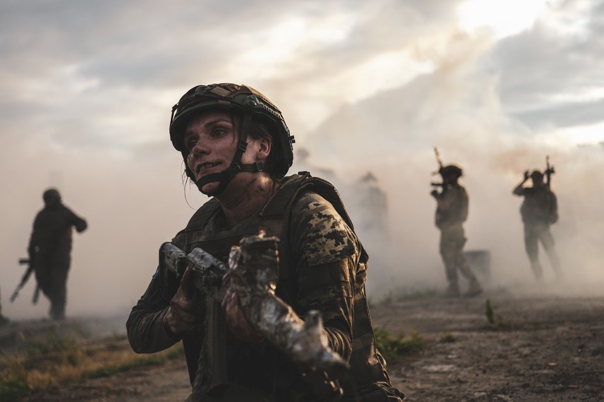 ZAPORIZHZHIA, UKRAINE - JULY 15: Female members of the Ukrainian Army&#039;s 128th Carpathian Mountain Assault Brigade train in different combat scenarios including various obstacles in conditions sim ...