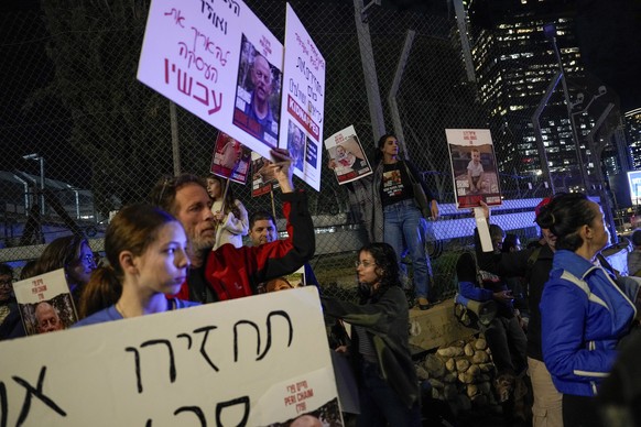 Israeli protesters call for the release of the hostages held in the Gaza Strip by the Hamas militant group, in Tel Aviv, Tuesday, Nov. 28, 2023. AP Photo/Ariel Schalit)