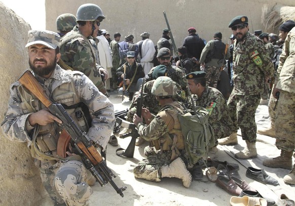 Afghan security forces are seen after Taliban militants opened fire on delegation of senior Afghan officials in Panjwai, Kandahar province south of Kabul, Afghanistan, Tuesday, March. 13, 2012. Taliba ...