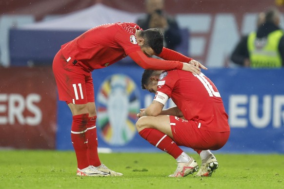 Switzerland&#039;s disappointed Renato Steffen, left, and Granit Xhaka after the UEFA Euro 2024 qualifying group I soccer match between Romania and Switzerland at the National Arena stadium in Buchare ...