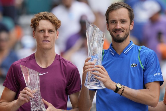 Daniil Medvedev, of Russia, right, and Jannik Sinner, of Italy, pose with their trophies after Medvedev beat Sinner, 7-5, 6-3, during the men&#039;s singles finals of the Miami Open tennis tournament, ...