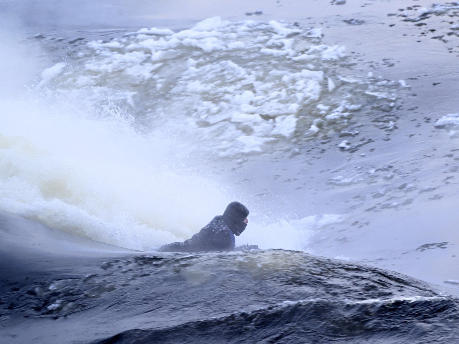 Carlos Hebert Plante boogie boards on the St. Lawrence River in Montreal, Friday, Feb. 3, 2023. Plante boogie boards all year, even on days like Friday where the temperature dipped to -26 C. (Bernard  ...