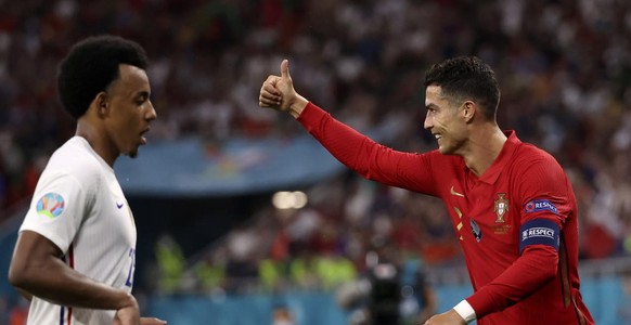 Portugal&#039;s Cristiano Ronaldo gestures next to France&#039;s Jules Kounde, left, during the Euro 2020 soccer championship group F match between Portugal and France at the Puskas Arena in Budapest, ...