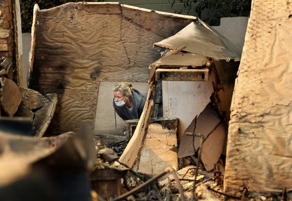 PACIFIC PALISADES, CA, JANUARY 11, 2025: Ana Ashby, takes a moment to process the loss of her home in Pacific Palisades on Saturday, January 11, 2025. (Christina House / Los Angeles Times via Getty Im ...