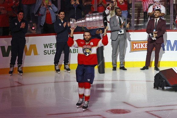 SUNRISE, FLORIDA - OCTOBER 7: Aaron Ekblad #5 of the Florida Panthers brings the Stanley Cup onto the ice prior to the start of the game against the Chicago Blackhawks at the Amerant Bank Arena on Oct ...