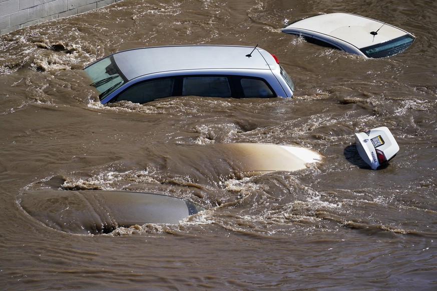 Vehicles are under floodwater from Schuylkill River in the Manayunk section of Philadelphia, Thursday, Sept. 2, 2021 in the aftermath of downpours and high winds from the remnants of Hurricane Ida tha ...