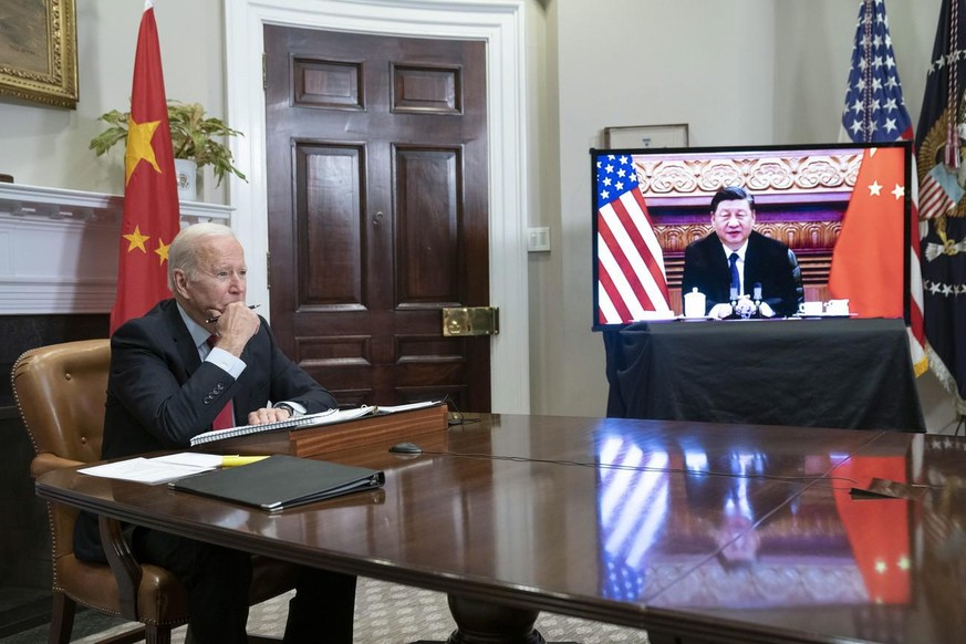 epa09584529 US President Joe Biden listens during a virtual summit with Chinese President Xi Jinping in the Roosevelt Room of the White House in Washington DC, USA, 15 November 2021. EPA/SARAH SILBIGE ...