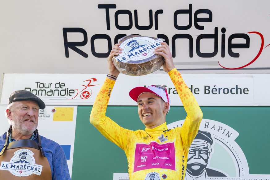 epa12067833 Overall leader Alex Baudin from France of team EF Education-Easypost celebrates on the podium with the yellow jersey and a cheese after the second stage of the Tour de Romandie cycling tou ...