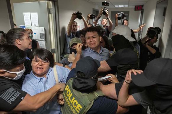 KEYPIX - Federal agents detain Carlos Javier Lopez Benitez, center, from Paraguay as they pull away his sister, Porfiria Lopez, a U.S. citizen, left, outside immigration court at the Jacob K. Javits f ...