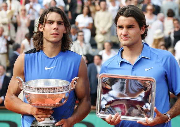 Spain's Rafael Nadal, left, and Switzerland's Roger Federer pose with their trophy after the men's final match during the French Open tennis tournament at the Roland Garros stadium in P ...