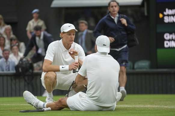 Italy&#039;s Jannik Sinner checks on Bulgaria&#039;s Grigor Dimitrov after he went down with an injury during a fourth round men&#039;s singles match at the Wimbledon Tennis Championships in London, M ...