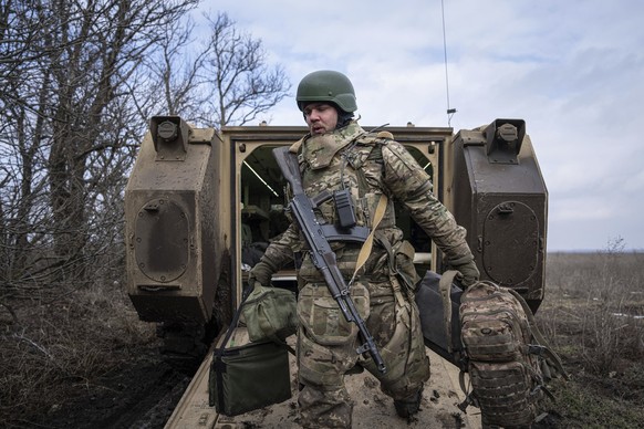 A Ukrainian serviceman of 68 Oleksa Dovbush hunting brigade disembarks from M113 armoured vehicle at frontline near Vuhledar, Ukraine, Wednesday, Feb. 22, 2023. (AP Photo/Evgeniy Maloletka)