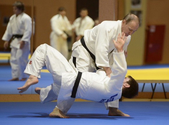 Russian President Vladimir Putin, top, competes against Musa Mogushkov, member of Russia Judo team during their training session in the resort city of Sochi, Russia, Friday, Jan. 8, 2016. After Russia ...