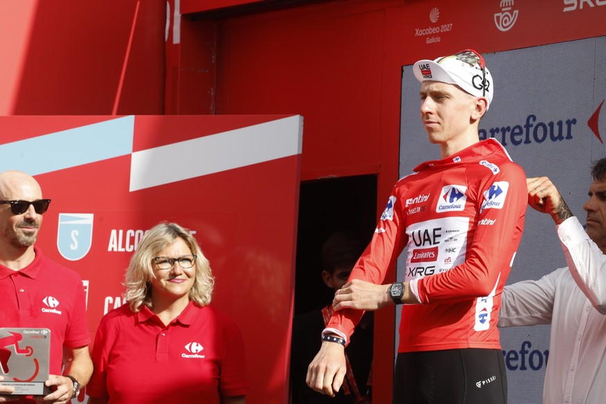 epa13194854 Slovenian rider Tadej Pogacar of team UAE Team Emirates XRG wearing the overall leader's red jersey poses on the podium after the 6th stage of the La Vuelta a Espana cycling tour, a r ...