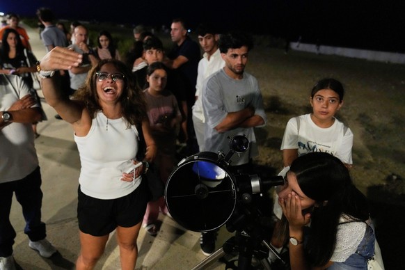 People gather to look through a telescope during a lunar eclipse in downtown Beirut, Sunday, Sept. 7, 2025. (AP Photo/Hussein Malla)
Lebanon Lunar Eclipse