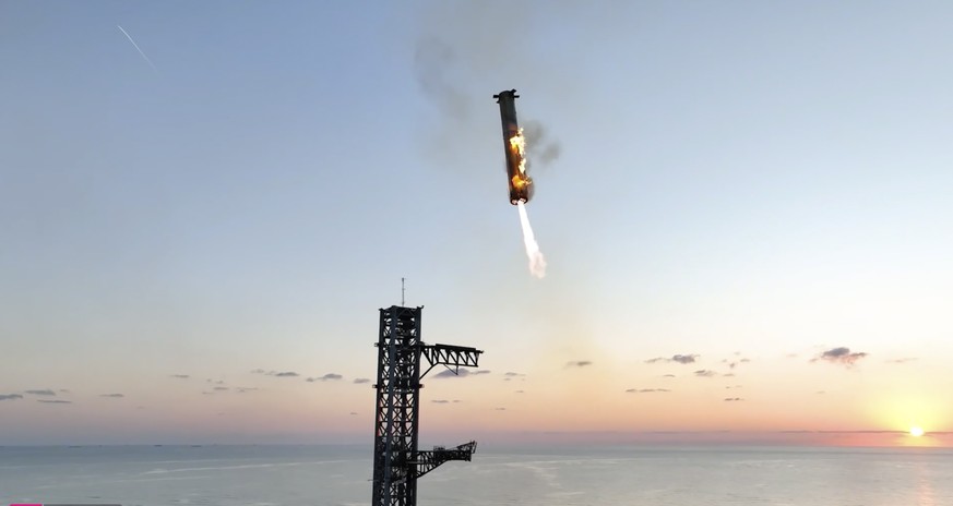 This image provided by SpaceX shows SpaceX&#039;s mega rocket booster returning to the launch pad to be captured during a test flight Sunday, Oct. 13, 2024, in Boca Chica, Texas. (SpaceX via AP)