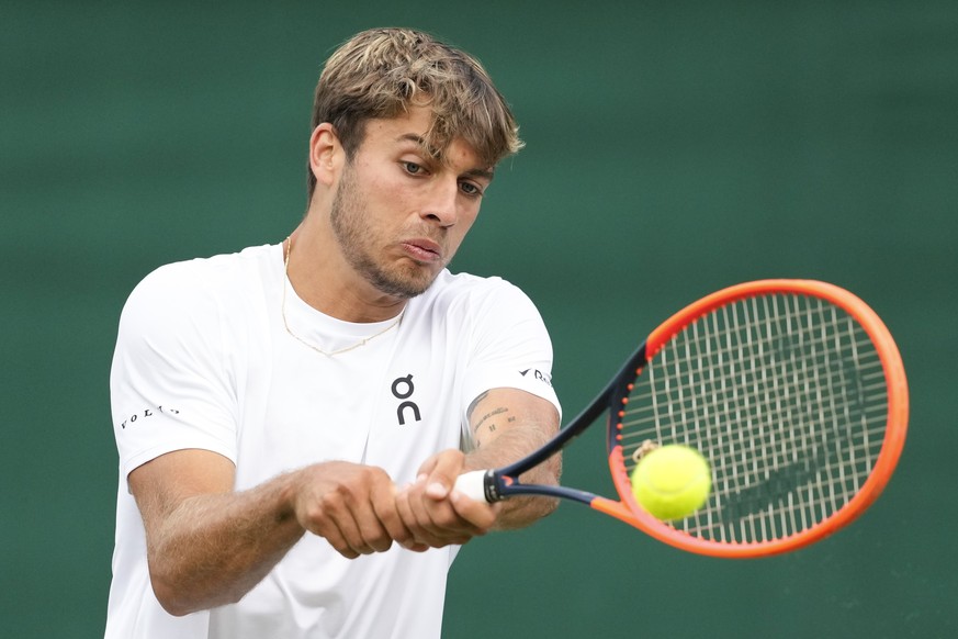 Flavio Cobolli of Italy plays a backhand return to Alejandro Tabilo during their second round match at the Wimbledon tennis championships in London, Thursday, July 4, 2024. (AP Photo/Mosa&#039;ab Elsh ...