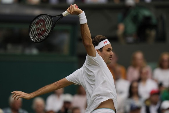 Switzerland&#039;s Roger Federer plays a return during the men&#039;s singles third round match against Britain&#039;s Cameron Norrie on day six of the Wimbledon Tennis Championships in London, Saturd ...