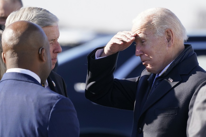 President Joe Biden greets Missouri Gov. Mike Parson and Kansas City, Mo., Mayor Quinton Lucas, front left, as he arrives at Kansas City International Airport, Wednesday, Dec. 8, 2021, in Kansas City, ...