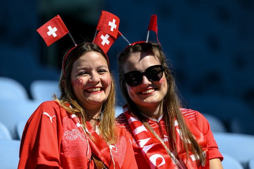 Two fans of the Swiss team smile before the FIFA World Cup Qatar 2022 group G soccer match between Switzerland and Cameroon at the Al-Janoub Stadium in Al-Wakrah, south of Doha, Qatar, Thursday, Novem ...