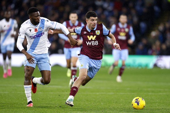 Burnley&#039;s Zeki Amdouni, right, and Crystal Palace&#039;s Jefferson Lerma battle for the ball during the English Premier League soccer match between Crystal Palace and Burnley FC at Turf Moor, in  ...
