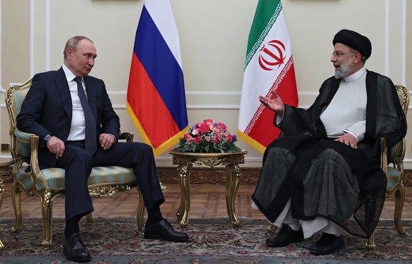 epa10079903 Russian President Vladimir Putin (L) and Iranian President Ebrahim Raisi (R) attend a meeting in Tehran, Iran, 19 July 2021. Russian President is on a working visit in Iran to take part in ...