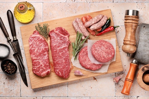 Various raw meat. Steaks, sausages, burgers and spices. Flat lay