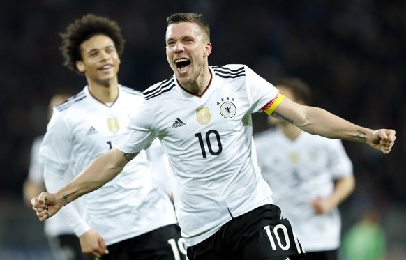 epa05864595 Lukas Podolski (C) of Germany celebrates after scoring the 1-0 lead during the international friendly soccer match between Germany and England in Dortmund, Germany, 22 March 2017. EPA/FRIE ...