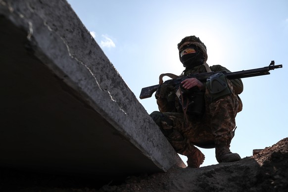 epa09849337 A Ukrainian soldier in trench as he take his position in the southern Ukrainian city of Mykolaiv, Ukraine, 25 March 2022. Russian troops entered Ukraine on 24 February resulting in fightin ...