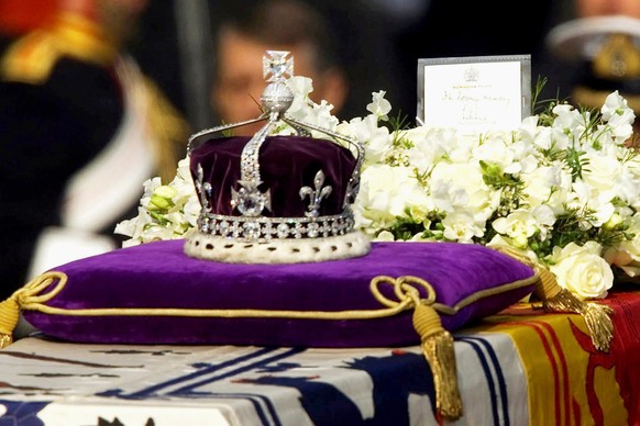 FILE - The Koh-i-Noor diamond, set in the Maltese Cross at the front of the crown made for Britain's late Queen Mother, is seen on her coffin as it is drawn to London's Westminster Hall on A ...