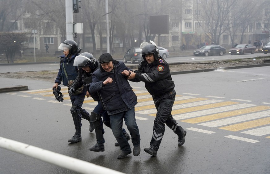 Police officers detain a demonstrator during a protest in Almaty, Kazakhstan, Wednesday, Jan. 5, 2022. Demonstrators denouncing the doubling of prices for liquefied gas clashed with police in Kazakhst ...
