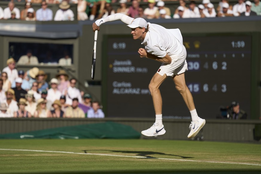 LONDON, ENGLAND - JULY 13: Jannik Sinner of Italy serves the ball against Carlos Alcaraz of Spain during Gentlemens&#039; singles final on Centre Court on day fourteen of The Championships Wimbledon 2 ...