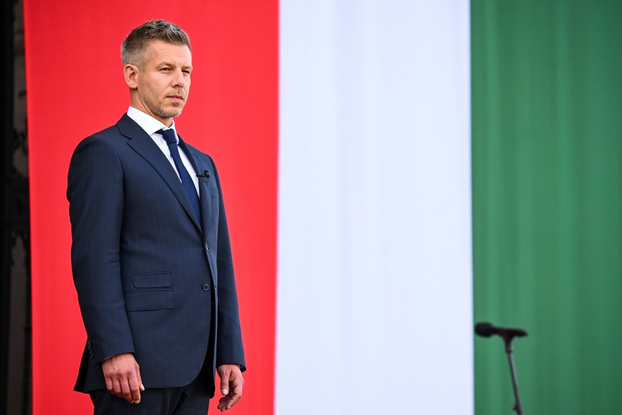 epa12943979 Newly sworn-in Prime Minister Peter Magyar stands in front of the parliament building after the inaugural session of the new National Assembly in the parliament building in Budapest, Hunga ...