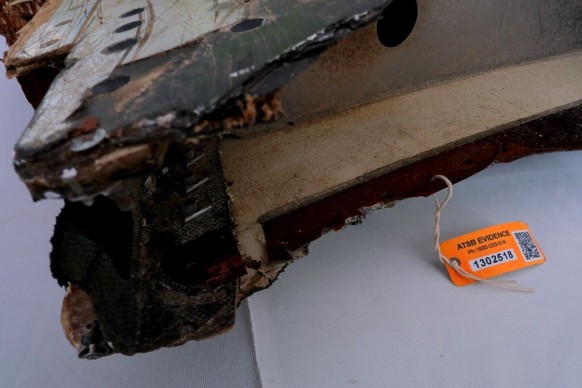 KUALA LUMPUR, MALAYSIA - MARCH 3: Debris from the wing flap part of Malaysia Airlines with an identification tag had found in Pemba Island, Tanzania display on the table during 5 Years of Remembrance  ...