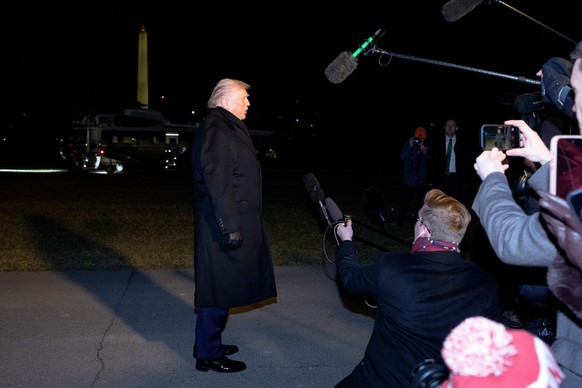 epa12666274 US President Donald J Trump (L) speaks to the media on the South Lawn of the White House in Washington, DC, USA, 20 January 2026. President Trump is heading to Davos, Switzerland, to atten ...