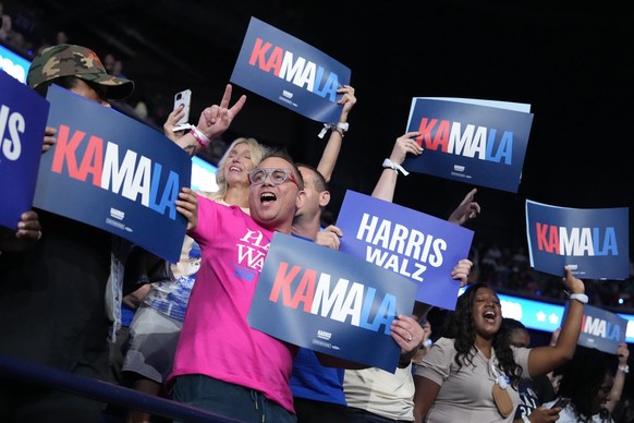 Supporters holding signs cheer before Democratic presidential nominee Vice President Kamala Harris arrives to speak during a campaign event, Thursday, Sept. 12, 2024, in Greensboro, N.C. (AP Photo/Chr ...