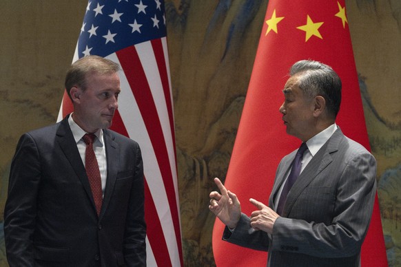 Wang Yi, right, the director of the Communist Party&#039;s Central Foreign Affairs Commission Office speaks to White House national security adviser Jake Sullivan, left, before their talk at Yanqi lak ...
