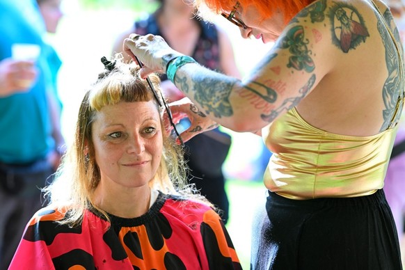 A woman has her hair cut during the annual European Mullet Cup in Audregnies, southern Belgium, on May 23, 2026. This year's European championship is the fourth to be held since a group of enthus ...