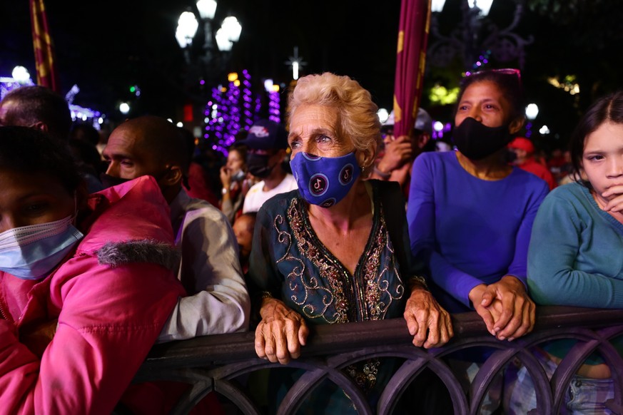 epa09597028 Groups of people attend an event organized by Chavismo while waiting for the results of the voting, in Bolivar Square, Caracas, Venezuela, 21 November 2021. More than 21 million Venezuelan ...