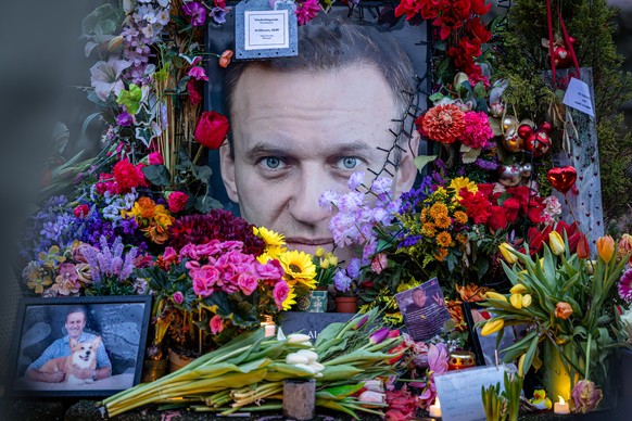 epa12747684 People lay flowers at a memorial for late opposition leader Alexei Navalny, ahead of his commemoration at Frederiksplein, in Amsterdam, The Netherlands, 16 February 2026. Navalny died in 2 ...