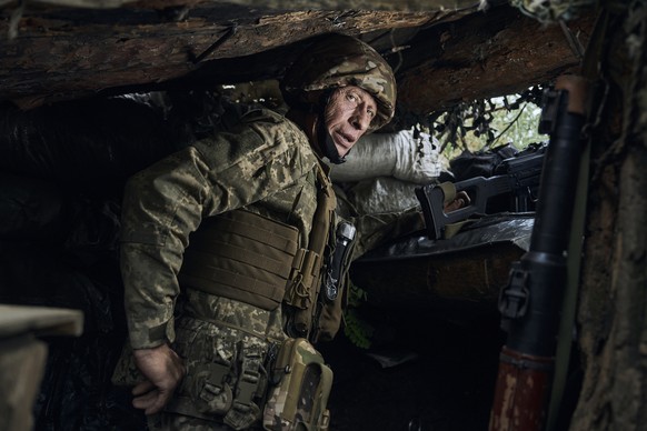 A Ukrainian soldier looks on in a trench on the frontline in the Zaporizhzhya region, the site of the heaviest battles with the Russian troops, Ukraine, Thursday, Aug. 10, 2023. (AP Photo/Libkos)