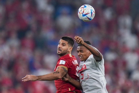 Switzerland's Manuel Akanji, right, heads for the ball with Serbia's Aleksandar Mitrovic during the World Cup group G soccer match between Serbia and Switzerland, at the Stadium 974 in Doha, ...