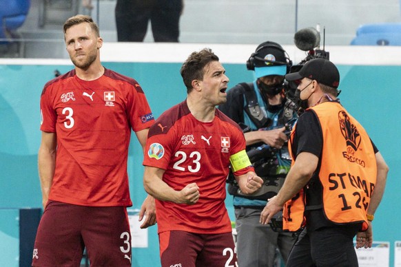 Switzerland&#039;s forward Xherdan Shaqiri, right, celebrates after scoring the equalizer goal to 1:1 next to defender Silvan Widmer, during the UEFA Euro 2020 soccer tournament quarterfinal soccer ma ...