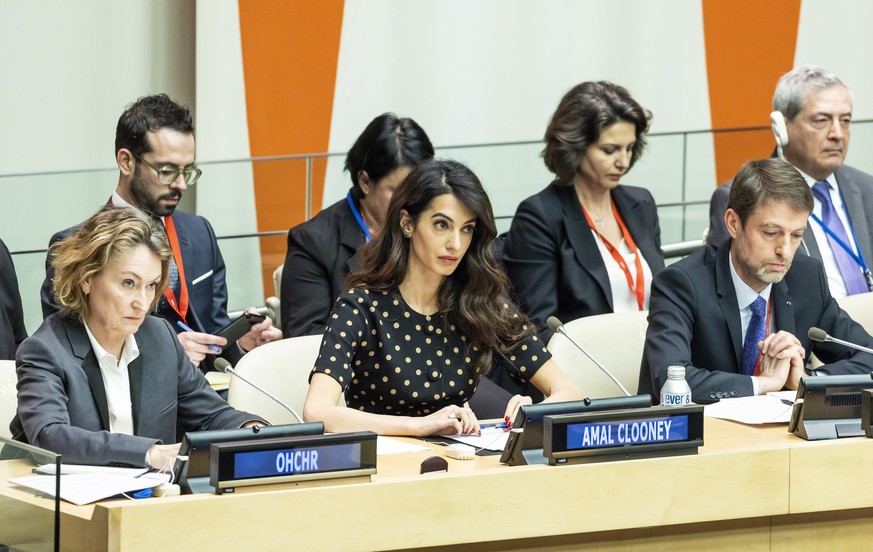 epa09913076 Human rights attorney Amal Clooney (3-L) sits with Ilze Brands Kehris (L), UN Assistant Secretary-General for Human Rights, during a meeting discussing ways to create accountability for do ...