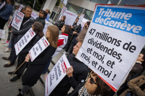 Des journalistes et employes de Tamedia Suisse romande brandissent des pancartes lors d&#039;un debrayage protestant contre un projet de restructuration impliquant la suppression de 290 postes et la f ...
